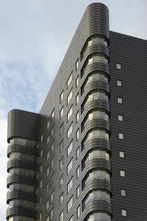 Closeup modern apartment building against blue sky