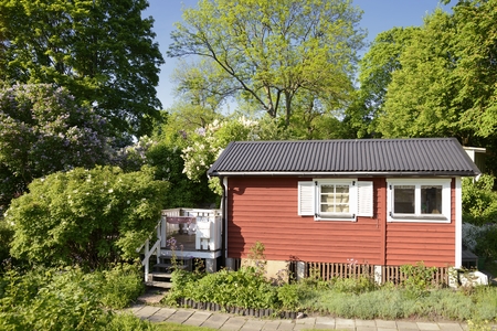 Idyllic red cottage in botanical gardenの写真素材
