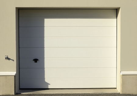 Garage door, half in shadow, half in sunshine.の写真素材