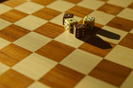 Stack of dices on brown wooden board background