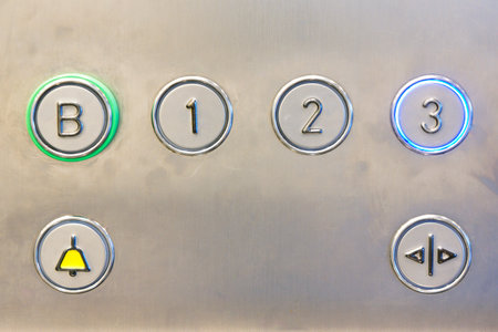 Closeup of metal buttons in an elevator background