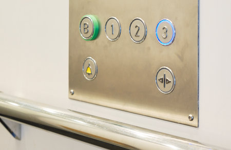 Closeup of metal buttons in an elevator backgroundの写真素材