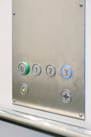 Closeup of metal buttons in an elevator background
