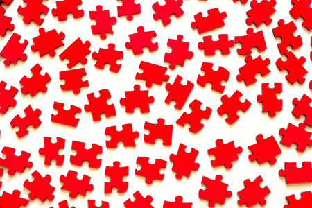 Different red puzzle pieces on white table backgroundの写真素材
