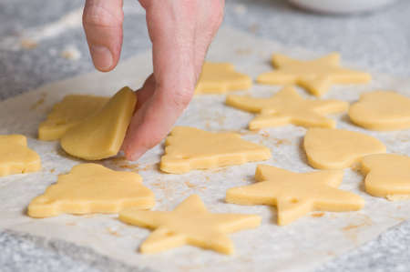Placing star and heart shape cookies after cutting on backing paperの写真素材