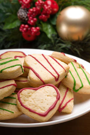 Decorated christmas cookies in festive setting with tree decorationの写真素材