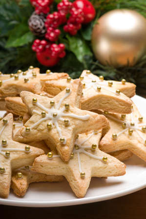 Decorated christmas cookies in festive setting with tree decorationの写真素材