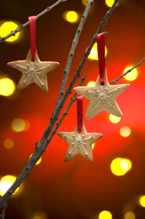 Christmas cookies as tree decoration with a red gold back froundの写真素材