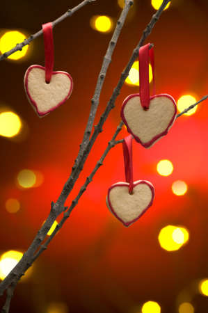 Christmas cookies as tree decoration with a red gold back froundの写真素材