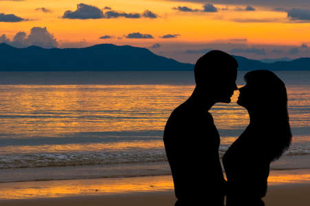 Couple in love at sunset on the beachの写真素材