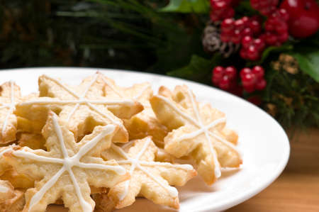 Decorated christmas cookies in festive setting with tree decorationの写真素材