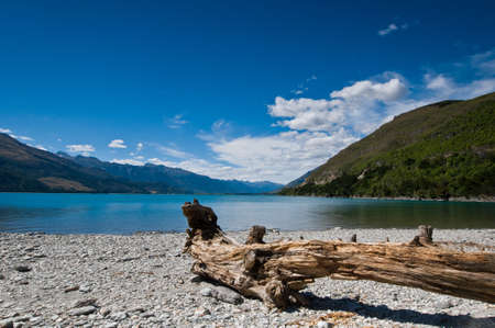 A lake during a sunny day with blue skyの写真素材