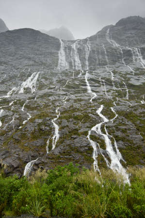 The many waterfalls during rain showers in New Zealandの写真素材