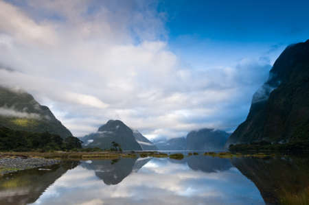 Cloudy morning at milford sound with sunrise in the back groundの写真素材