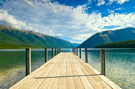 Jetty of a beautiful lake during mid dayの写真素材