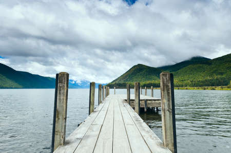 Jetty of a beautiful lake during mid dayの写真素材