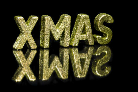 In capital letter written Xmas, glitter effect over blackの写真素材