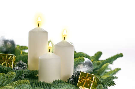 Three candles in advent setting with real Christmas tree branchesの写真素材
