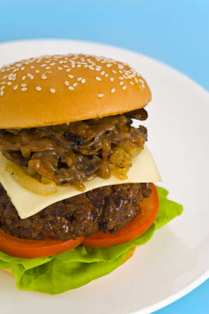 Classic Hamburger with cheese tomato salad and roasted onionsの写真素材