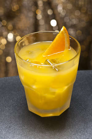 Screwdriver cocktail in front of different colored backgroundsの写真素材