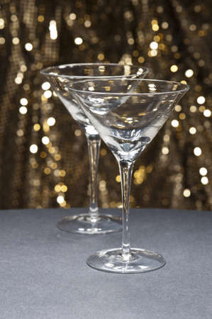 Martini glasses in front of glitter background
