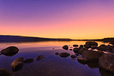 Sunset Sunrise above a lake beautiful glowing sun effect の写真素材