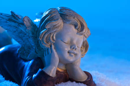 Angel in a beautiful blue snow settingの写真素材