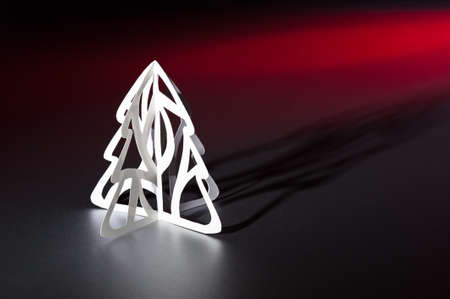 Paper cut Christmas tree in red and white with long shadowの写真素材