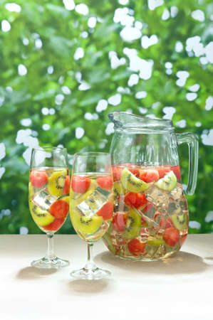 Kiwi Melon Sangria in front of green shrubsの写真素材