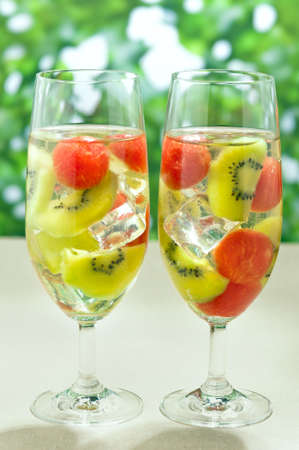 Kiwi Melon Sangria in front of green shrubbsの写真素材