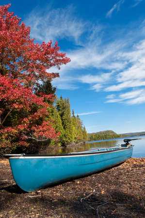 Kayak, Boat during sunny day at a lake with blue skyの写真素材