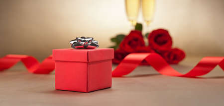Champagne glasses and roses in front of beige backgroundの写真素材