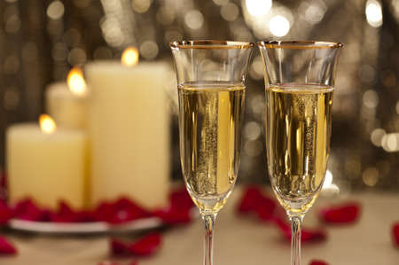 Gold glitter Wedding reception setting with champagne and candlesの写真素材