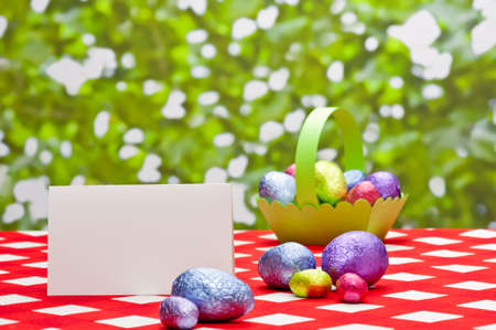 Easter eggs in basket in a spring setting with place cardの写真素材