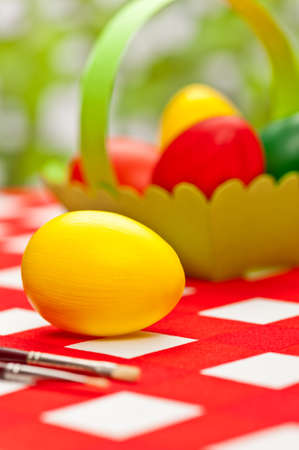 Handcrafted easter eggs with green egg basketの写真素材