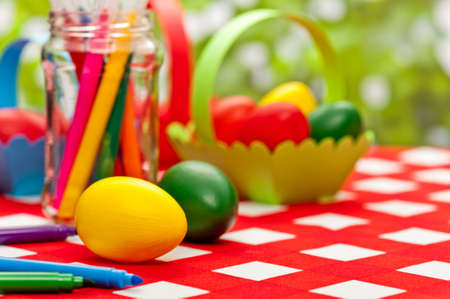 Handcrafted easter eggs with green egg basketの写真素材