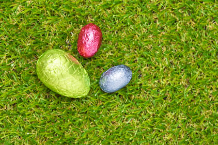 Three Chocolate Easter eggs on a lawnの写真素材