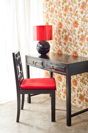 Luxury work desk with floral wallpaper next to bright windowの写真素材