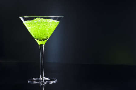 Apple Martini cocktail in front of disco lightsの写真素材