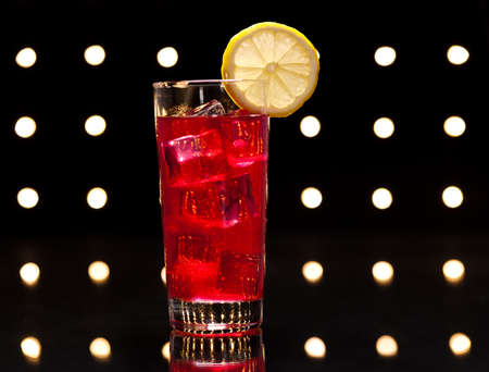 Red Campari Cocktail in longdrink glass with lemon decorationの写真素材