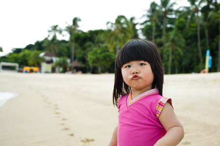 Young toddler at the beach having fun and is curiosの写真素材