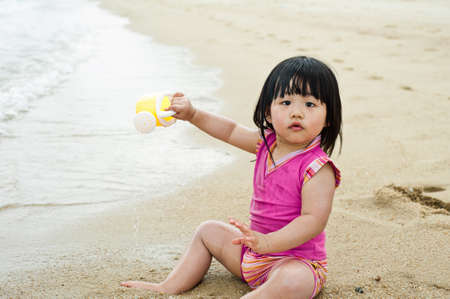 Young toddler at the beach having fun and is curiosの写真素材