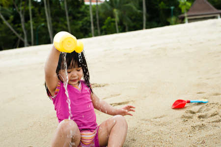 Young toddler at the beach having fun and is curiosの写真素材