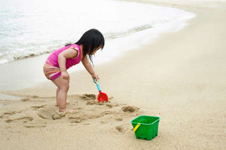 Young toddler at the beach having fun and is curiosの写真素材