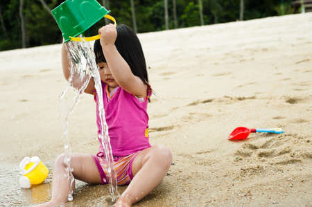 Young toddler at the beach having fun and is curiosの写真素材
