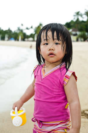 Young toddler at the beach having fun and is curiosの写真素材