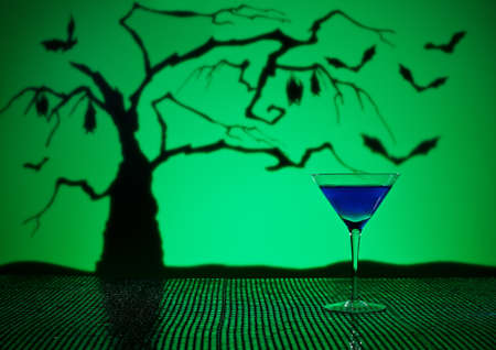 Cobalt Martini in Halloween setting with bats and a treeの写真素材