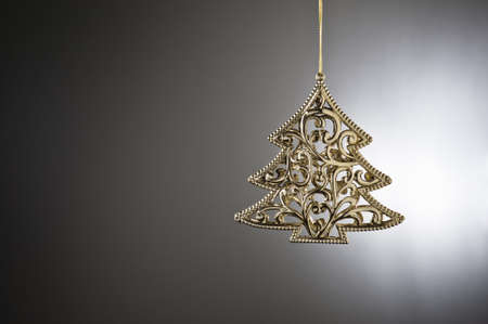 Christmas tree ornament in from of a Christmas treeの写真素材