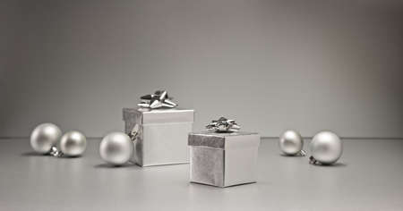 Silver bauble and present in Christmas settingの写真素材