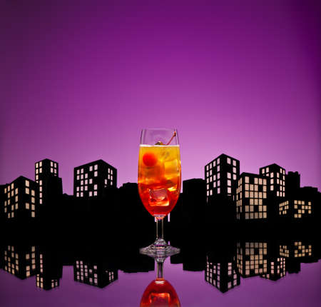 Metropolis Tequila Sunrise cocktail in city skyline settingの写真素材